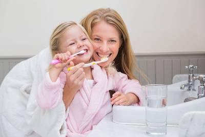 Mother and daughter brushing teeth | Chelsea Heights Dentist