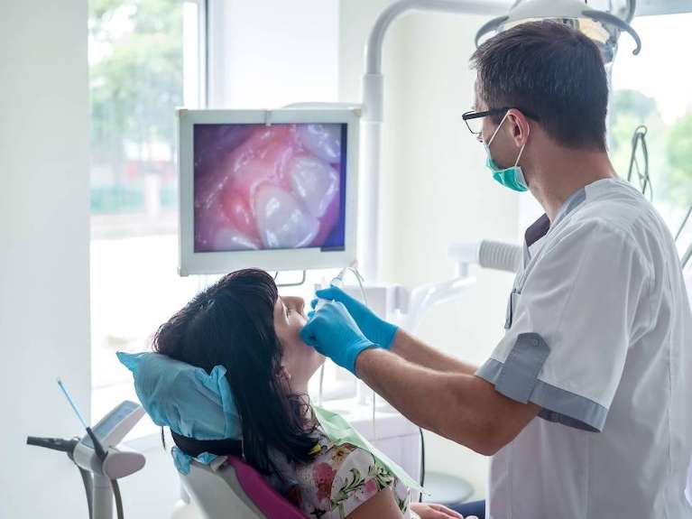 dentist with intraoral camera in chelsea heights